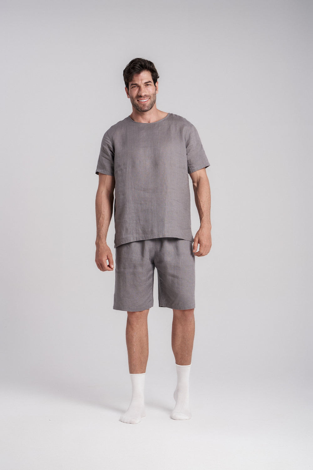 Men's short-sleeve linen sleepwear in gray, casual pose