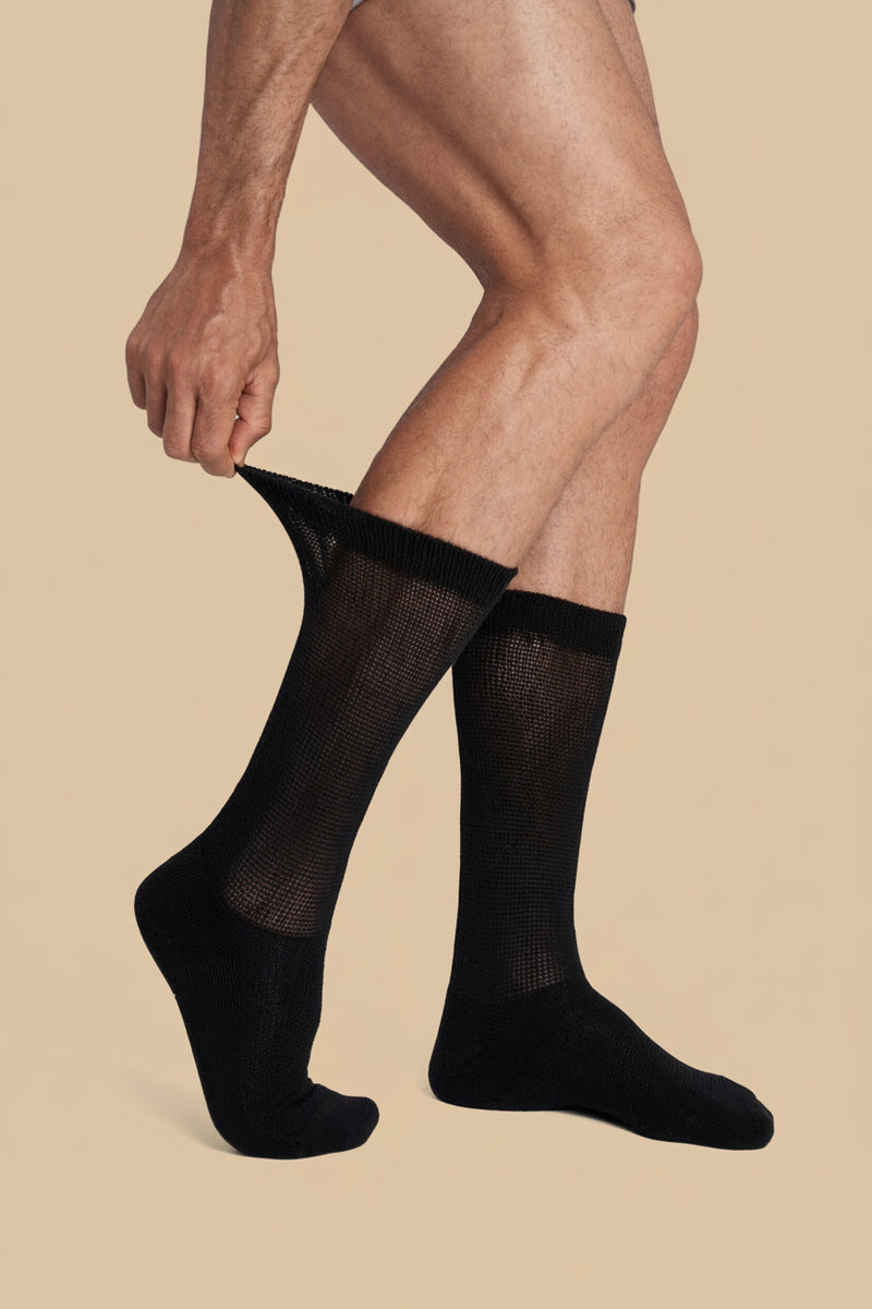 Black diabetic non-binding sock being pulled up