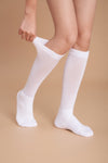 White women's diabetic non-binding socks being pulled up