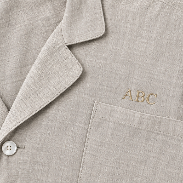 Personalized sleepwear with beige monogram ABC above the pocket