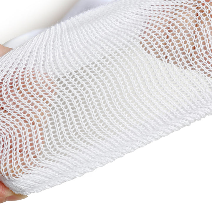 Close-up of white mesh fabric held by a hand on a white background