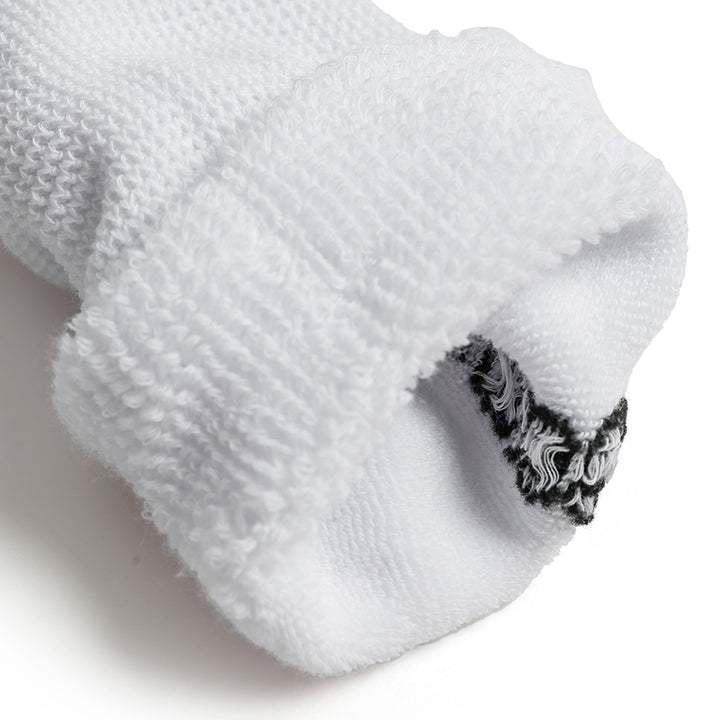 Close-up of a white sock with black patterned heel on a light background