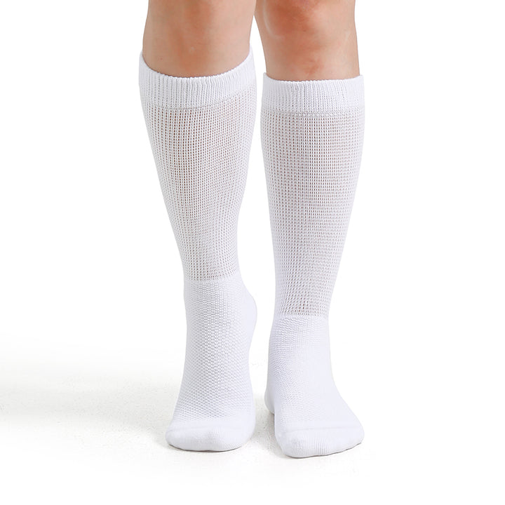 White knee-high socks worn by a person on a white background