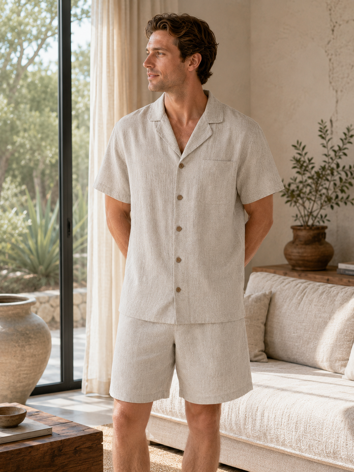 Man wearing hemp short-sleeve sleepwear set standing by window in bright living room